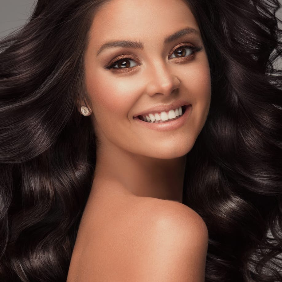 Smiling model looking over her shoulder and smiling.